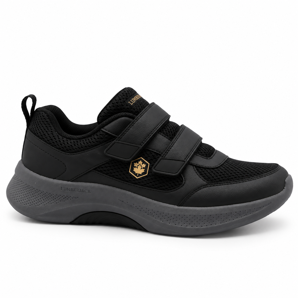 A black low-top athletic shoe with hook-and-loop strap closures, a gold hexagonal logo on the side, and a dark gray sole, shown against a plain white background.